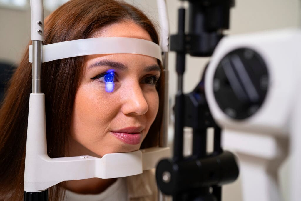 A female patient undergoes a comprehensive eye examination with an ophthalmic machine, a crucial first step in the diagnosis of Intermittent Squint.